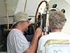 Technicians adjusting a devise on one of Alvins manipulator arms.