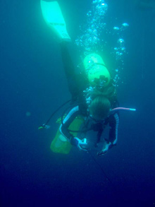 Blue water divers use glass jars to capture gelatinous specimens for further study in the ships laboratory.