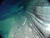 Interlayered basaltic (dark) and felsic (light) ash layers in the east wall of West Rota caldera.