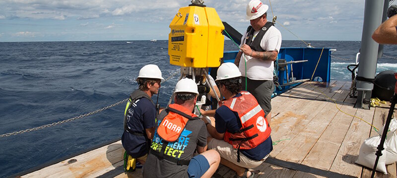 Project team members prepare the transponder pod.