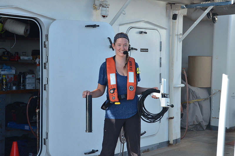 Mapping Watchstander, Neah Baechler, prepares to put the expendable bathythermograph (XBT) equipment away after deploying an XBT. XBTs are launched every ~2-6 hours to acquire temperature data of the water column down to 760 meters (2,493 feet). These data are used to estimate water column refraction required for multibeam sonar data.