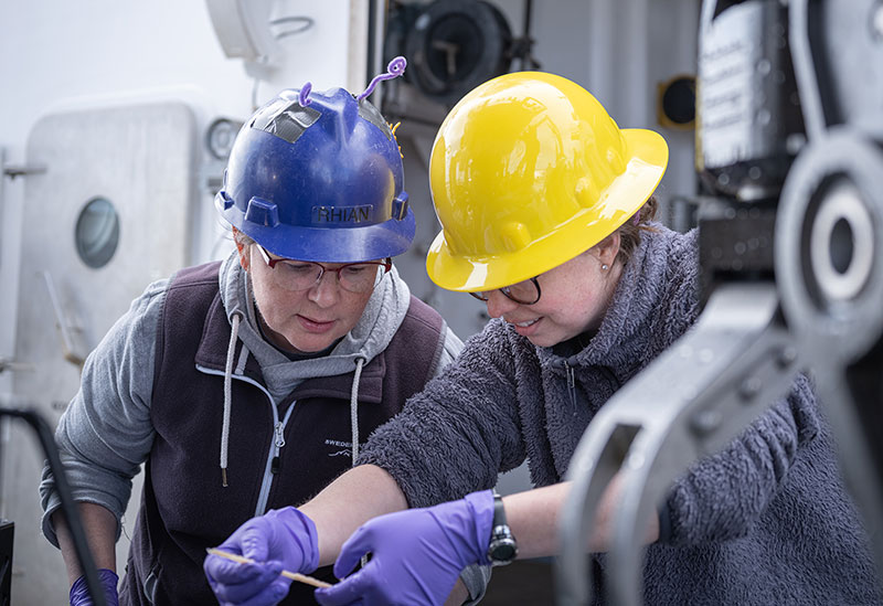 Seascape Alaska 3 expedition biology science lead Rhian Waller and sample data manager Anna Lienesh examine a sample collected during the second dive of the expedition.